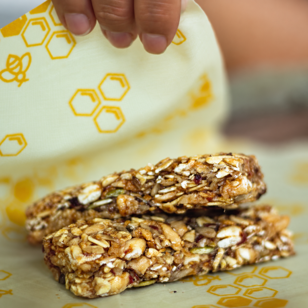 Granola bars resting on a honeycomb beeswax food wrap