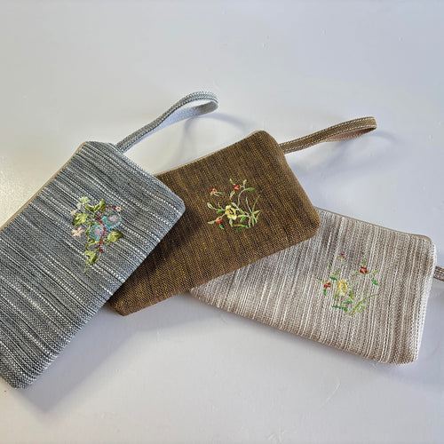 Embroidered Ramie Wristlet Clutch design options shown in Xiabu ramie textile