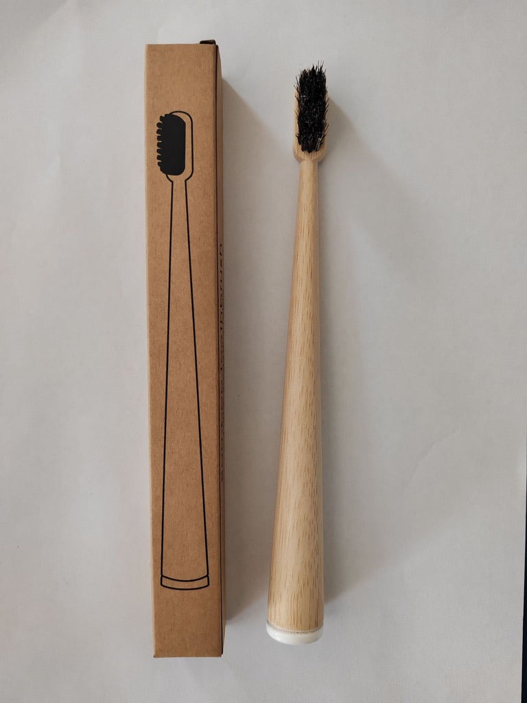 Single round bamboo toothbrush with dark horsehair bristles and a kraft paper box