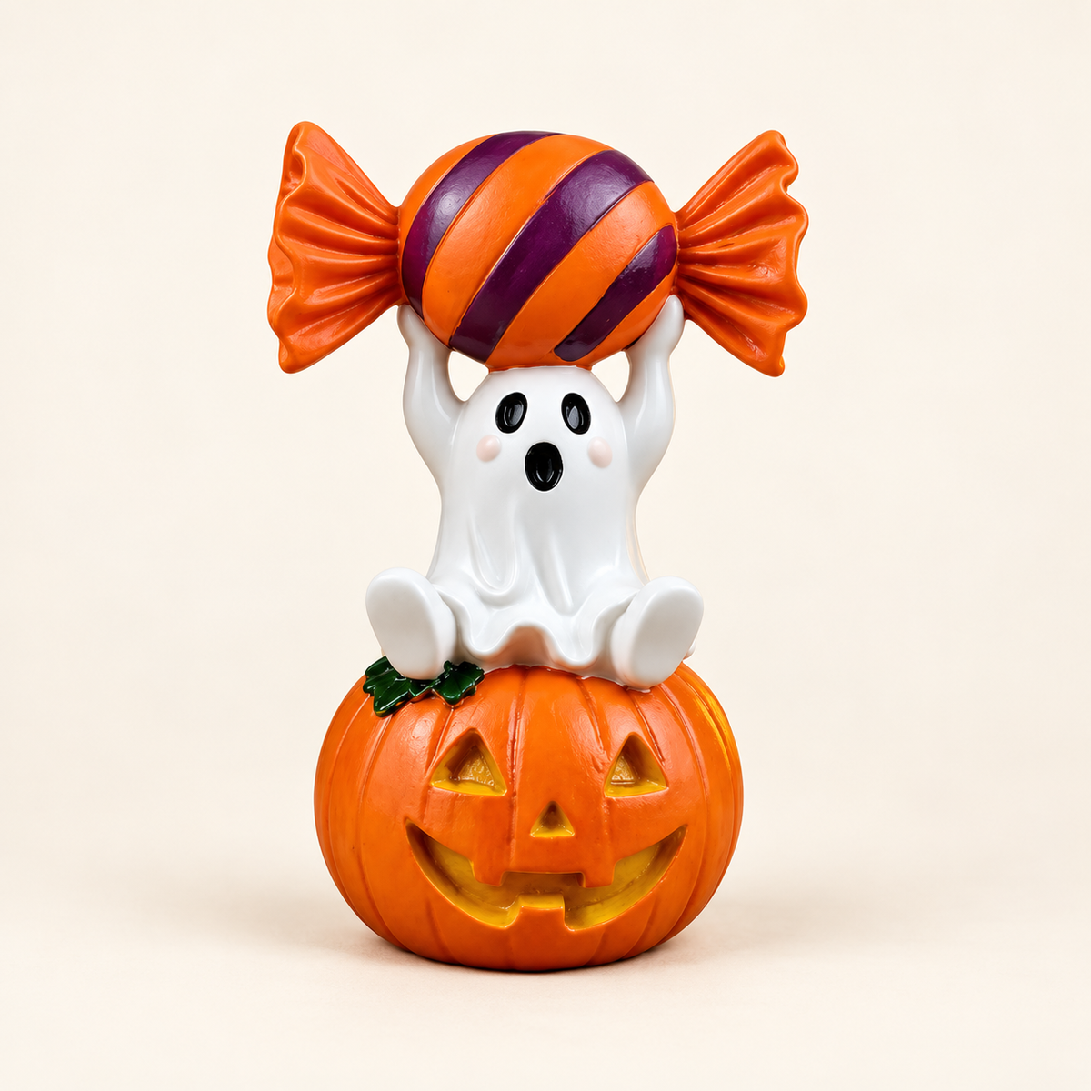 Ghost holding orange and purple candy on a pumpkin resin decoration on an ivory background