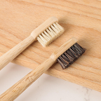 Close-up of light boar bristles and dark horsehair bristles on round bamboo toothbrushes