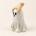 Hand and ghost Halloween resin decoration on an ivory background