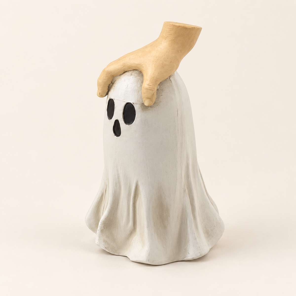 Hand and ghost Halloween resin decoration on an ivory background